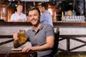 cheerful man holding pint.jpg