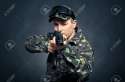 25519894-Soldier-aiming-a-machine-gun-with-a-focus-on-the-barrel-machine-Stock-Photo.jpg