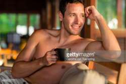 492605771-smiling-man-with-coffee-cup-looking-off-gettyimages.jpg