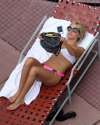 78950_celebrity_paradise.com_TheElder_AshleyTisdale2011_10_23_workonhertanbythepoolinMiamiBeach7_122_47lo.jpg