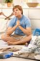 7249385-Young-guy-sitting-on-living-room-floor-looking-up-troubled-about-housework-surrounded-by-laundry--Stock-Photo.jpg