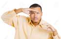 26127239-Closeup-portrait-of-a-young-serious-curious-squinting-man-hand-on-head-peering-ahead-searching-for-s-Stock-Photo.jpg