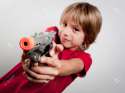 10774458-little-boy-with-gun-toy-Stock-Photo.jpg