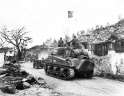 3rd_Marine_Division_Troops_and_M4_Sherman_Tank_Moves_thru_Agana_Guam.jpg