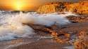 sea_waves_splashes_stones_rocks_sun_sunset.jpg
