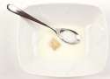 17723915-One-piece-of-ceral-floats-in-the-milk-in-a-white-square-cereal-bowl-Stock-Photo.jpg