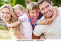stock-photo-portrait-of-happy-family-in-garden-156648317.jpg