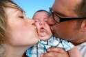 parents-kissing-baby.jpg