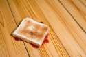 Slice-of-toast-with-strawberry-jam-upside-down-on-floor.jpg