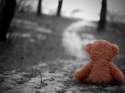 teddy-bear-sitting-alone-road.jpg