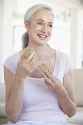 senior-woman-eating-brown-bread-roll-7874896.jpg