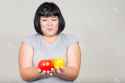 47468794-Fat-Asian-woman-holding-fruits-Stock-Photo.jpg