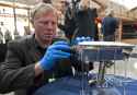 Mike_Simons,_Director_of_the_National_Electronic_Museum_in_Baltimore_assembles_an_Apollo_TV_camera_for_display.png