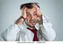 stock-photo-panic-of-a-businessman-with-head-in-his-hands-in-a-white-shirt-on-a-light-background-258957287.jpg