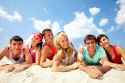 10130626-Three-happy-couples-lying-on-sand-and-looking-at-camera-Stock-Photo.jpg
