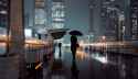 women-hand-holding-umbrella-walking-in-the-winter-rain-on-a-street-in-Shanghai-city.jpg