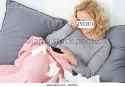crying-woman-lying-on-couch-holding-cell-phone-ehxk2j.jpg