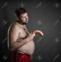 43236467-Side-view-of-fat-man-with-a-sausage-in-his-hand-Potency-problem-Stock-Photo.jpg