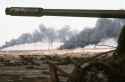 Disabled_Iraqi_T-54A,_T-55,_Type_59_or_Type_69_tank_and_burning_Kuwaiti_oil_field.jpg