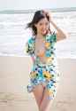 Asian chick one tit out on the beach 01.jpg