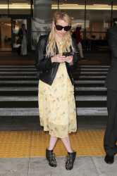 Emma-Roberts-in-Yellow-Dress-at-LAX--05.jpg