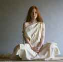 woman in cloak sitting.png