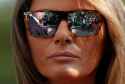 Melania_Trump_with_Donald_in_sunglasses_reflection.jpg