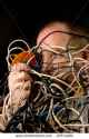 stock-photo-man-tangled-in-wires-29714404.jpg