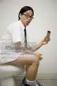 640-01351782em-portrait-of-a-young-man-sitting-on-a-toilet-stock-photo.jpg